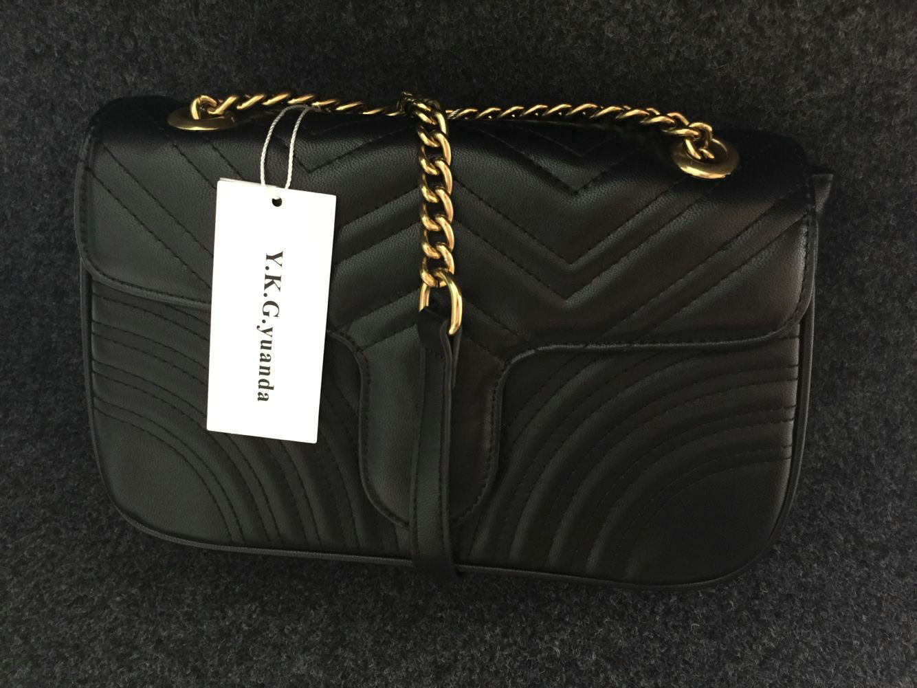 black shoulder bag with gold chain strap